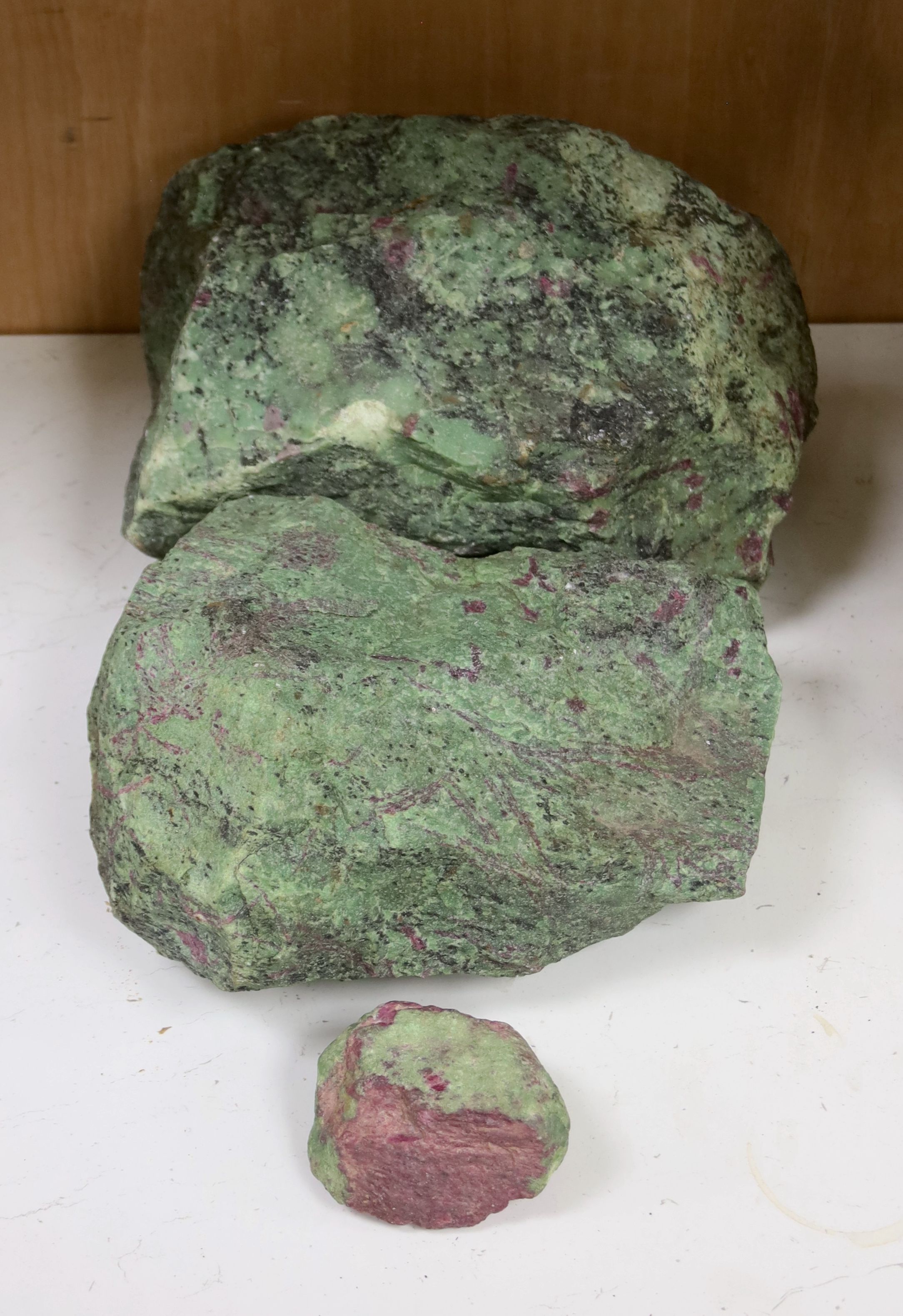 Three fragments of Anyolite (or ruby in zoisite) originating from a ruby mine in Kenya, largest 32 x 22cm